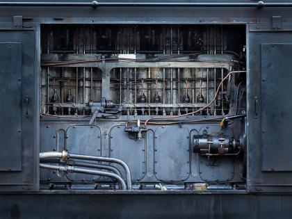 old part of a machine, dark looks like a part of a locomotive